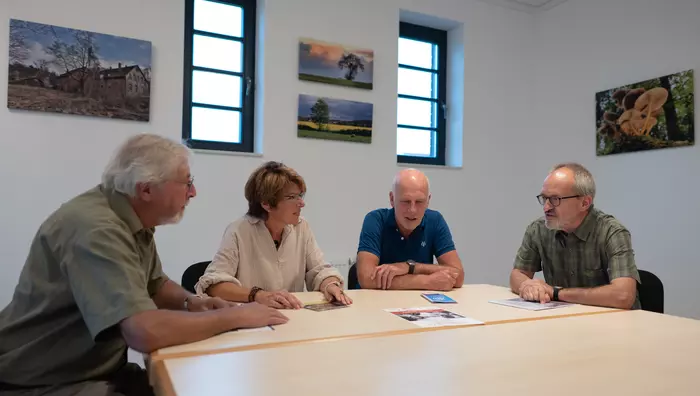 3 Herren und eine Frau am Besprechungstisch