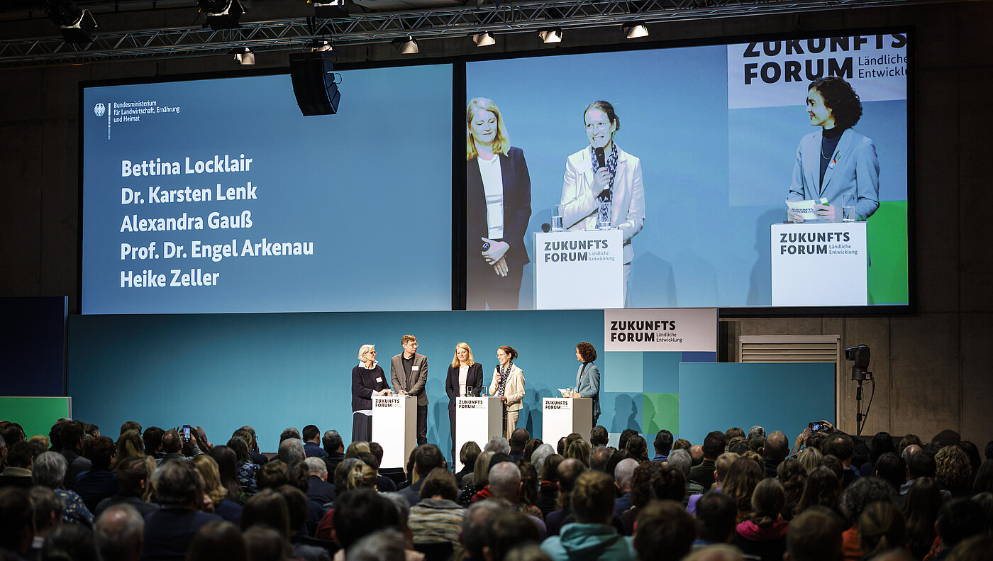 5 Teilnehmende des 19. Zukunftsforums Ländliche Entwicklung bei der Eröffnungsveranstaltung auf der Bühne