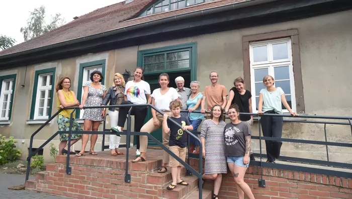 Die Teilnehmenden der Jahresgruppe stehen auf den Stufen des Pfarrhauses