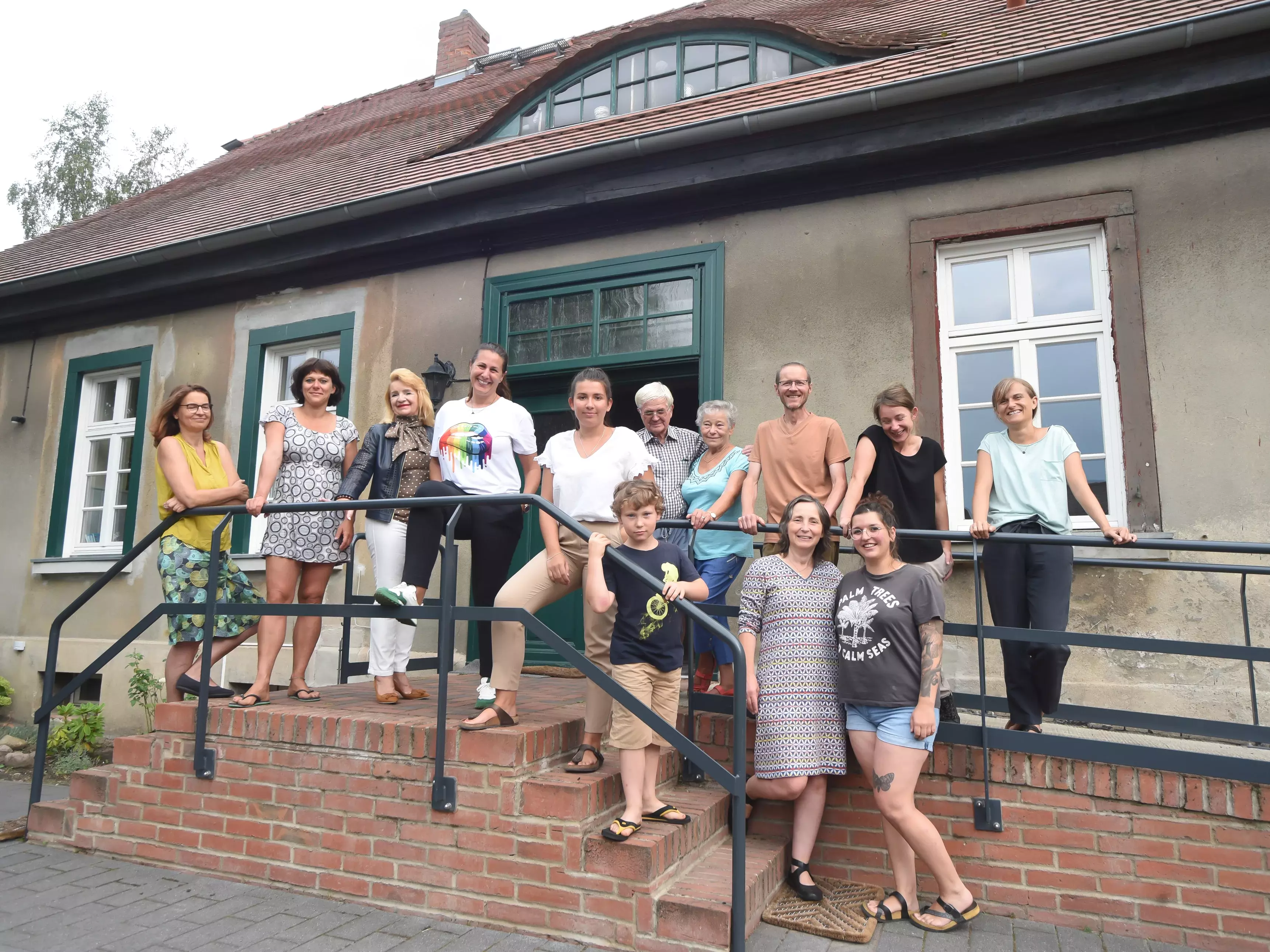 Die Teilnehmenden der Jahresgruppe stehen auf den Stufen des Pfarrhauses  